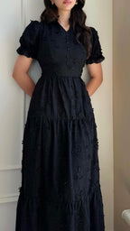 Black maxi dress with textured pattern and tiered skirt