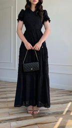 Black maxi dress with textured pattern and tiered skirt