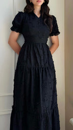 Black maxi dress with textured pattern and tiered skirt