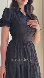 Black maxi dress with textured pattern and tiered skirt